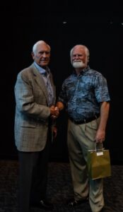 Fred Derr, 35 year Mote Volunteer shakes hands with Mote President and CEO Dr. Michael Crosby.